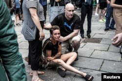 A woman reacts in front of the Field's shopping centre, after Danish police said they received reports of a shooting at Field's shopping center, in Copenhagen, Denmark, July 3, 2022.