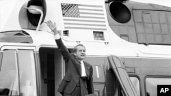 FILE - In this Aug. 9, 1974 file photo, President Richard Nixon waves goodbye from the steps of his helicopter outside the White House, after he gave a farewell address to members of the White House staff.