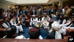 Mullah Abdul Ghani Baradar, the Taliban group's top political leader, left, Sher Mohammad Abbas Stanikzai, the Taliban's chief negotiator, second left, and other members of the Taliban delegation speak to reporters in Moscow, Russia, May 28, 2019.