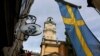 FILE - Sweden's flag is seen near the Stockholm Cathedral in Gamla Stan or the Old Town district of Stockholm, Sweden.