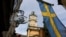 FILE - Sweden's flag is seen near the Stockholm Cathedral in Gamla Stan or the Old Town district of Stockholm, Sweden.
