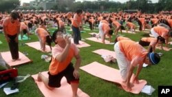 A Bengal tiger reacts while cooling off in a pond inside a cage during a hot summer day at Alipore Zoological Garden in Kolkata, India.