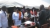 Malawi official Agnes Chatipwa (left) looks over some of the donated medical supplies and furniture ..(VOA-L. Masina) 