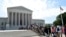 FILE - People wait in line to go into the Supreme Court in Washington.