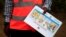 An Ugandan health worker shows an informational flyer on Ebola virus and how to prevent its spread to the community of Kirembo village, near the border with the Democratic Republic of Congo, in Kasese district, Uganda, June 15, 2019. 