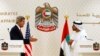 U.S. Secretary of State John Kerry (L) reaches out to shake hands with UAE Foreign Minister Abdullah bin Zayed Al Nahyan at the foreign ministry in Abu Dhabi, Nov. 11, 2013.