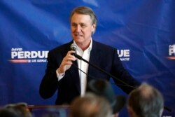 FILE - Republican candidate for Senate Sen. David Perdue speaks at Peachtree Dekalb Airport in Atlanta, Nov. 2, 2020.