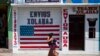 FILE - A closed business featuring a U.S. flag and the Spanish phrase "Send to U.S.A" is pictured in the largely indigenous town of Joyabaj, Guatemala, where half of the residents depend on remittances, almost all from the United States, April 3, 2020.