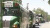 Buses transporting Nigerian returnees are seen in Maroua, northern Cameroon, March 8, 2021. (Moki Edwin Kindzeka/VOA)