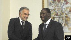 International Criminal Court's chief prosecutor Luis Moreno-Ocampo, left, is greeted by Ivory Coast President Alassane Ouattara in Abidjan, Ivory Coast, October 15, 2011.