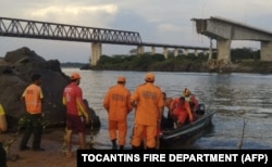 This handout photo released by the Tocantins Fire Department shows firefighters after the Juscelino Kubitschek de Oliveira bridge fell on Dec. 22, 2024, over the Tocantins River at the city of Aguiarnopolis, Tocantins state, Brazil.