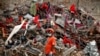 A Bangladeshi rescuer stands amid the rubble of a garment factory building that collapsed on April 24 as they continue searching for bodies in Savar, near Dhaka, Bangladesh, May 12, 2013.