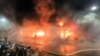In this image taken from video by Taiwan's EBC, firefighters battle a blaze at a building in Kaohsiung, in southern Taiwan, Oct. 14, 2021.