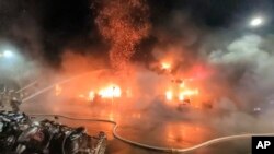 In this image taken from video by Taiwan's EBC, firefighters battle a blaze at a building in Kaohsiung, in southern Taiwan, Oct. 14, 2021.
