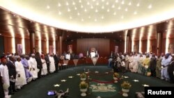 Nigeria's President Muhammadu Buhari swears in ministers into his cabinet in Abuja, Nigeria November 11, 2015. Buhari swore 36 ministers into his cabinet on Wednesday, five months after his inauguration. Buhari won March elections after vowing to crack do