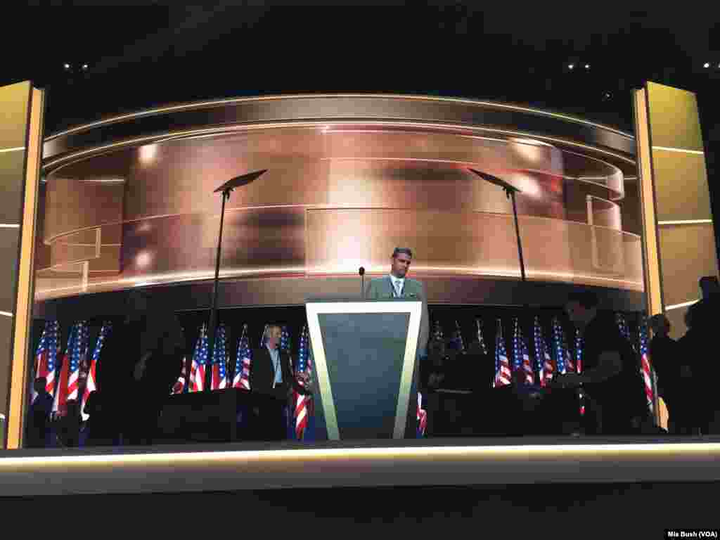 A convention worker stands behind the new podium put in place Thursday morning for the prime-time speakers, which will include Donald Trump, as he accepts the Republican Party's presidential nomination, in Cleveland, July 21, 2016.