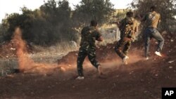 Free Syrian Army soldiers aim their weapons in Idlib, northern Syria, July 13, 2012.
