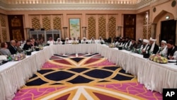 FILE - U.S. and Taliban officials conferring in an undisclosed place in Doha, Feb. 25, 2019.