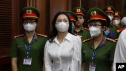 Vietnamese real estate tycoon Truong My Lan, front center, is escorted into a courtroom in Ho Chi Minh city, Vietnam, Tuesday, March 5, 2024. (Phan Thanh Vu/VNA via AP)