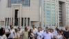 FILE - Journalist are seen gathered outside a court building to support a colleague who was detained in connection with the investigation launched into the recent failed coup attempt in Turkey, in Istanbul, July 27, 2016.