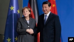 中国国家主席习近平与德国总理默克尔今年早些时候在柏林会晤