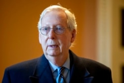 Senate Minority Leader Mitch McConnell, R-Ky., speaks to a reporter at the Capitol in Washington, Jan. 19, 2022.
