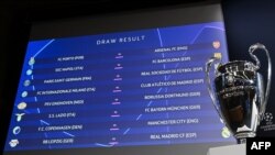 চ্যাম্পিয়ন্স লীগের শেষ-১৬ পর্বে কে কার সাথে খেলবে, তা বাছাই করার জন্য ড্র শেষে ফলাফল স্ক্রীনে দেখা যাচ্ছে, পাশে ট্রফি। 