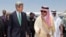 U.S. Secretary of State John Kerry, left, is greeted by Saudi Foreign Minister Prince Saud al-Faisal upon arrival in Jeddah, Saudi Arabia, June 25, 2013.
