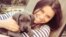 FILE - Cancer patient Brittany Maynard, shown with her Great Dane puppy, on Saturday took a lethal dose of medication prescribed by a doctor.
