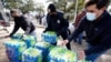 Donated water is distributed to residents, Feb. 18, 2021, in Houston. The city and several surrounding cities were under a boil water notice as many residents were still without running water in their homes. 