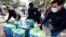 Donated water is distributed to residents, Feb. 18, 2021, in Houston. The city and several surrounding cities were under a boil water notice as many residents were still without running water in their homes. 