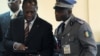 Ivory Coast's internationally recognized President Alassane Ouattara (L) uses an iPad prior to attending African Union talks in Addis Ababa, March 10, 2012. 