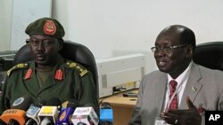 FILE - South Sudanese Minister of Information Barnaba Benjamin Marial, right, and Military Spokesman Philip Aguer brief the median Juba, south Sudan about recent fighting between Sudanese and South Sudanese forces along the north-south border.