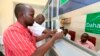 A Somali man collects his money at a Dahabshiil money transfer office in southern Mogadishu, May 8, 2013.