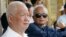 FILE - Former Khmer Rouge leaders Khieu Samphan, left, and Nuon Chea sit together during funeral services for the first wife of Khmer Rouge leader Pol Pot, July 3, 2003. The two were convicted Friday of war crimes.
