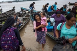 Members of the Israelites of the New Universal Pact religious group arrive at a weekend market along the banks of the Amazon River, in Alto Monte de Israel, Peru, March 28, 2021.