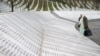 A woman stands near a grave of her family members in the memorial center Potocari before the judges verdict on former Bosnian Serb political leader Radovan Karadzic's appeal of his 40-year sentence for war crimes, near Srebrenica, Bosnia and Herzegovina.