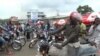 FILE - Liberian motorcyclists.