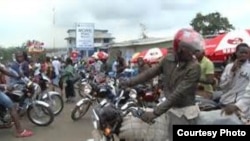 FILE - Liberian motorcyclists.