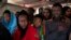 Migrants aboard the Golfo Azurro rescue vessel wait to be transferred to Italian authorities in Trapani harbor, on the Italian island of Sicily, Saturday, April 8, 2017.
