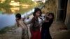 FILE - Rohingya girls carry water pots at Kutupalong refugee camp, in Cox's Bazar, Bangladesh, Nov. 19, 2017.