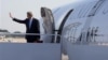 Secretary of State John Kerry waves as he boards his plane at Andrews Air Force Base, Md., June 21, 2013, en route to Doha, Qatar
