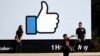 FILE - Visitors take photos in front of the Facebook logo at the company's headquarters, March 28, 2018, in Menlo Park, Calif.