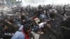 Thai policemen try to arrest anti-government protesters during their clash in Bangkok, Thailand Saturday, Nov. 24, 2012.