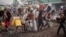 Residents carry their belongings as they flee from Kibati, where fighting has intensified, towards the city of Goma, Democratic Republic of Congo, Jan. 26, 2025. 