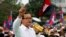 FILE - Sam Rainsy (C), leader of the opposition Cambodia National Rescue Party is seen speaking at a protest in central Phnom Penh, December 17, 2013.