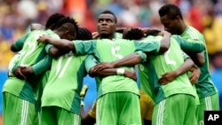 File: In this Monday, June 30, 2014 file photo, Nigeria's Emmanuel Emenike, center, looks up as his team form a huddle before the start of the second half during the World Cup round of 16 soccer match between France and Nigeria at the Estadio Nacional in 