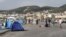 At the port in Lesvos, Greece, many refugees from Afghanistan, Iraq and Syria who cannot afford the 48 euros for a boat to their next destination wait in tents, many hoping to find another way, Sept. 12, 2015. (Credit: Heather Murdock/VOA)