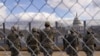 National Guard members salute in front of the U.S. Capitol building during the inauguration of President-elect Joe Biden in Washington, Jan. 20, 2021. 