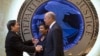 Attorney General Loretta Lynch, center, and Homeland Security Secretary Jeh Johnson, right, welcome Chinese Minister of Public Security Guo Shengkun to the Justice Department in Washington, Tuesday, Dec. 1, 2015.